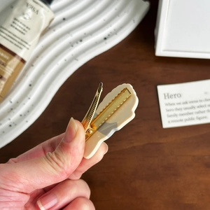 Chic cream acetate dog hair clip featuring a high-quality gold metal duckbill grip