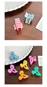 Close-up of matte macaron hair claws in bow and square shapes on a ceramic plate