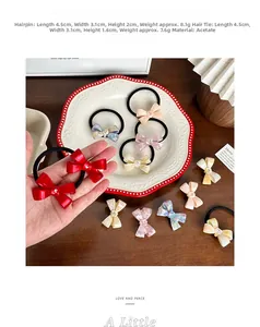 Detailed macro view of acetate bow hair ties with marble texture and crystal inlay