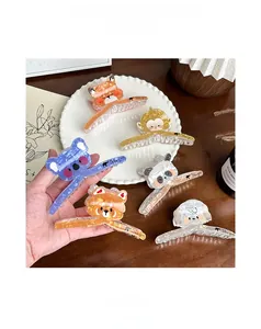 Close-up of cute acrylic animal hair claws including panda and monkey with marble texture