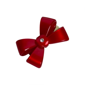 Elegant red acetate bow hair clip with central sparkling rhinestone on white background