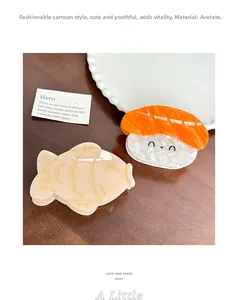 Close-up of acetic acid hair clips featuring cute salmon sushi and little fish designs