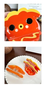 Detail of cute red sushi character hair claw and amber marble pattern acetate clip
