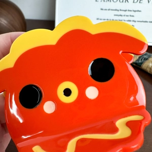 Cute sushi-style cartoon hair claw clip with glossy red finish and minimalist face detail