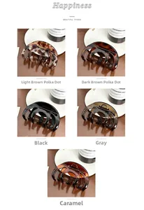 Close-up detail of large hair claw clips in leopard print and solid neutral colors