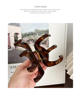 Detail of large dark brown tortoiseshell claw clip with strong metal spring for thick hair