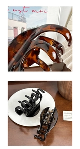 Detailed macro of large hair claw clip set showing tortoiseshell patterns and metal springs