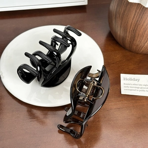 Large hair claw clips in glossy black and coffee tones for thick hair styling