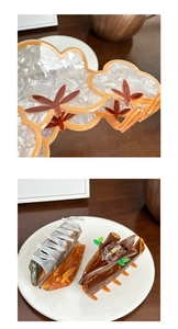 Detail of acrylic hair claws with maple leaf and wood textures featuring strong metal springs