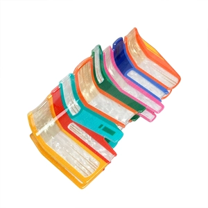 Colorful book-shaped acrylic hair claws with pearlescent finish on a white background