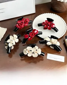 Detailed set of retro floral hair claws with red rose and creamy white flower designs
