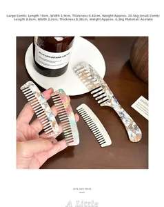 Detail view of acetate wide-tooth hair combs with marble texture on a wooden desk