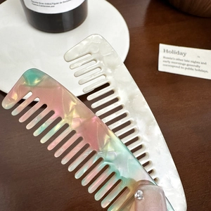 Elegant acetate wide-tooth hair combs in colorful pearl and creamy white finishes