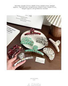 French vintage acetate claw clips in plaid and marble patterns on a ceramic tray