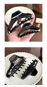 Detail of glossy black acetate hair claws in two sizes with gold France Handmade text