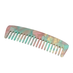 Portable wide-tooth acetate hair comb with colorful pastel marble texture on white background