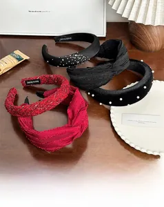 Detailed view of handmade velvet and pearl headbands with rhinestone accents