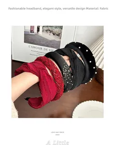 Detail of elegant pearl and rhinestone fabric headbands set styled on model arm