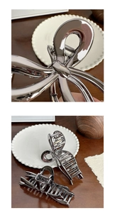 Detailed macro view of silver bow-knot metal hair claw clip with strong grip teeth