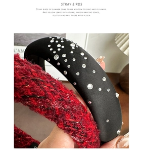 Close-up of black satin rhinestone headband and red tweed texture headband accessories
