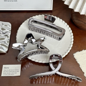Three-piece silver metal hair claw set in geometric star and rectangular designs