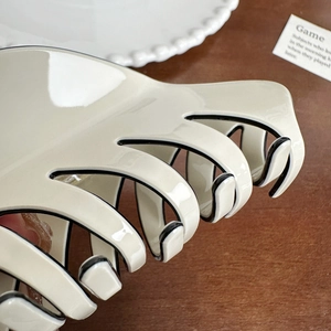 Elegant cream cellulose hair claw clip with black edges for thick hair styling