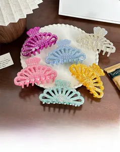 Detailed view of colorful luxury acetate hair claws with sparkling rhinestones in a tray