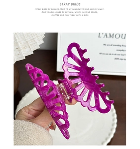 Detailed view of large purple acetate hair claw with rhinestones and marble texture