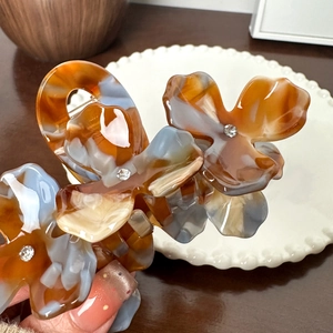 Floral acetate hair claw clip with marble pattern and sparkling rhinestones for women