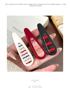 Set of three acetate hair clips in white, red and black featuring textured diamond patterns