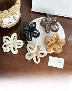Set of five matte plumeria flower hair claws in cream, beige, black, brown and tan colors