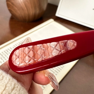 Ins style dark red marble textured hair clip held in hand for a vintage aesthetic look
