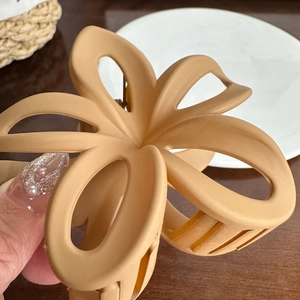 Elegant hollow frangipani hair claw clip in matte light coffee plastic for women hairstyle