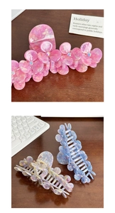 Detail of large acetate flower hair claw clips with rhinestones in pink and blue