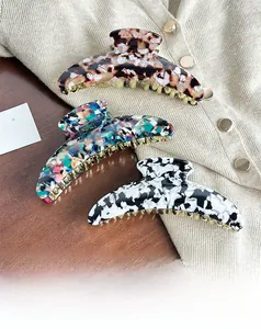 Three-piece large acetate hair claw clips in tortoiseshell and marble patterns