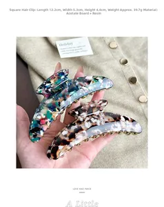 Large tortoiseshell and colorful acetate hair claw clips shown in hand for size detail