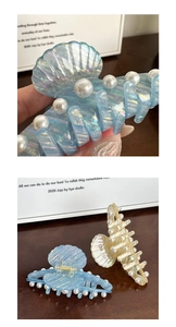 Macro detail of large shell-shaped hair claw clips with iridescent finish and pearls