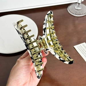 Large crescent hair claw clip in cow print acetate with premium metal spring and gear