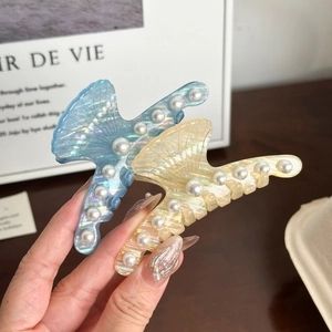 Pearlescent shell hair claws in blue and beige with white pearls for elegant styling