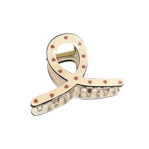 French style hair claw clip with red strawberry print on cream acrylic background