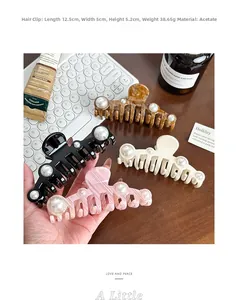 Detailed view of 12.5cm oversized acetate shark hair clips in assorted pearl patterns
