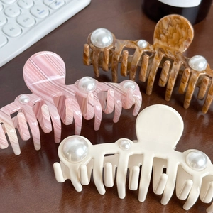 Oversized marble acetate hair claws with pearls in pink, amber, and cream white colors