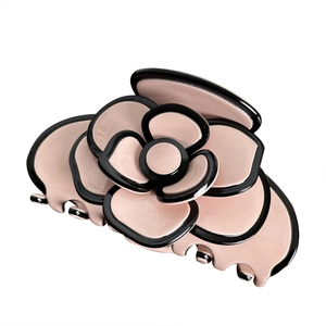 Elegant camellia hair claw clip in pink and black acetate with a glossy finish
