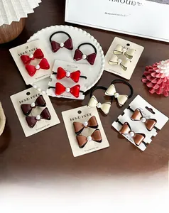 Détail d'un nœud papillon rouge élégant avec perle sur une assiette vintage blanche