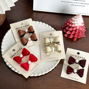 Barrettes à nœuds élégantes avec perles en marron, beige et rouge sur cartes