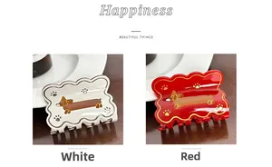 Detail of white and red dachshund pattern hair claws with smooth glossy acetate finish
