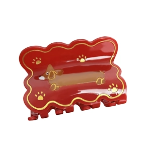Red acetate dachshund hair claw clip with gold wavy edges and paw prints for women