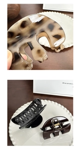 Detail view of heart-shaped hair claws in leopard print and glossy black finishes