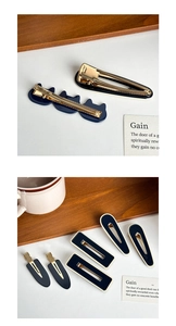 Detail view of navy blue acetate hair clips with premium gold metal duckbill base