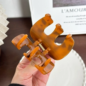 Minimalist heart-shaped amber claw clip hair accessory with strong metal spring